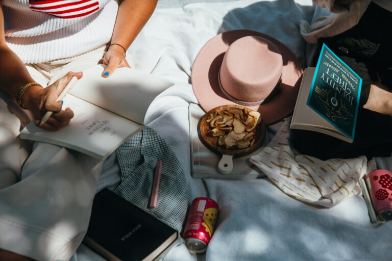 picnic in the park with books, wine, and snacks